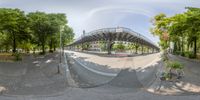 a wide angle view from inside an upside down fish eye view lens, of a bridge