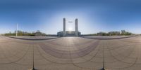 a circular panoramic lens photo shows two buildings on either side of the square