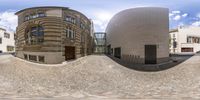 two spherical images of building with two buildings in the middle with a sky background on it