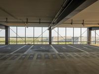 the empty garage area with no furniture or items, including a view of the water