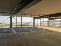 the empty garage area with no furniture or items, including a view of the water