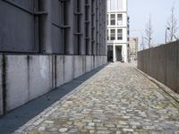 a brick sidewalk near a building in a city alley area of an urban area for urban purposes