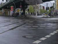 an intersection in paris with no sidewalks on it or on the street below the train tracks