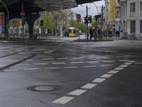 an intersection in paris with no sidewalks on it or on the street below the train tracks