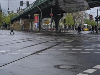 an intersection in paris with no sidewalks on it or on the street below the train tracks