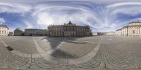 an image of a big square with some buildings and a person flying a kite in the air