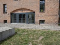 brick building with balcony and balconies on the side of it in an open field