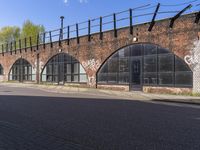 an old brick building with lots of windows and arched doorways at the top of it