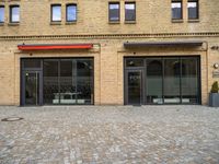 a brick parking lot with a fire hydrant and large windows on the side of it