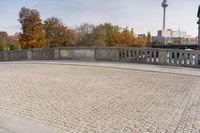 an empty bridge in the fall with an artistic painting on it's side on top