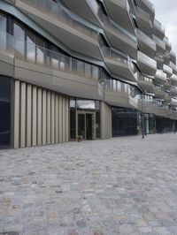 a brick paved patio and walkway with an office building in the background in london, england