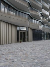 a brick paved patio and walkway with an office building in the background in london, england