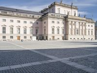 square with a church in front of the building and several other large buildings across from it