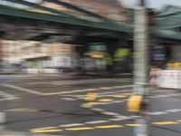 an blurry image of the street outside of a building that's under construction