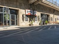 a cafe sitting on the side of a street in a city with no cars or buses