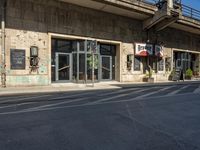 a cafe sitting on the side of a street in a city with no cars or buses