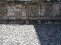 a picture of brick floor and walls and one large bench with red fire hydrant