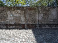 a picture of brick floor and walls and one large bench with red fire hydrant