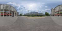 a fish eye view of a very big city with no traffic on the street and large buildings on either side