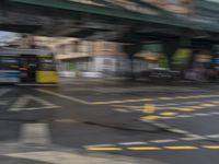 a city bus travels along the side of an overpass in this blurry photo