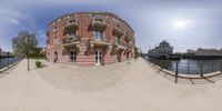 fisheye view of a building along a river in the city center of berlin, germany