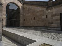 a stone building has several steps on each side of it to reach the building's front door