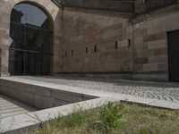 a stone building has several steps on each side of it to reach the building's front door