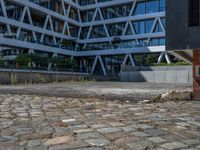 the building has several different angles on it, in varying colors and shapes with brick and concrete floors