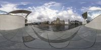 an abstract photo of a lake and buildings in a circular mirror effect design of the reflection