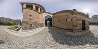 a 360 - shot with an intersection and a building with some windows and cobbles