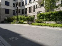 a row of houses next to a courtyard and landscaping area with stone path between buildings