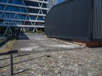 the building has several different angles on it, in varying colors and shapes with brick and concrete floors