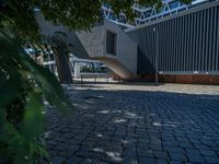the building has several different angles on it, in varying colors and shapes with brick and concrete floors