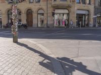 a street scene, with focus on the sign and pedestrians walking on the street in front