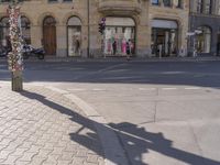 a street scene, with focus on the sign and pedestrians walking on the street in front