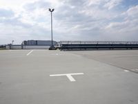 a boat is parked in an empty parking lot near an air port on the water