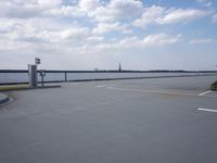 a boat is parked in an empty parking lot near an air port on the water