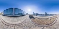 three fish - eye shots of some buildings and the sun reflecting on it's exterior