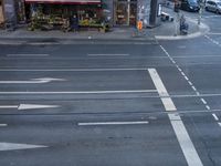 a trolley is traveling down the street at an intersection near a burger restaurant and a busy street