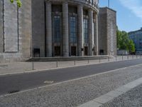 an entrance of a building with large columns and doors that spell out the word voltege