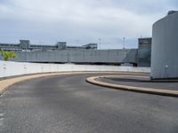 a car is driving on the highway through an underground parking garage area in a city