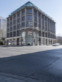a view of the street with buildings and car, with motion bluring in the foreground