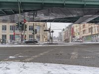 the cars are moving in opposite directions under the bridge over the street in this picture