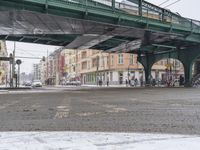 the cars are moving in opposite directions under the bridge over the street in this picture