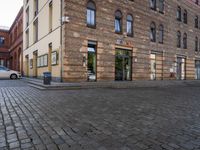 a stone street in an old european town with a cobbled path and building fronts