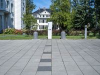 the block walkway has the two cement posts with the same square block that the sidewalk is located outside of