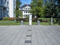 the block walkway has the two cement posts with the same square block that the sidewalk is located outside of