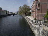 a very long waterway in front of an office building with a boat docked in it