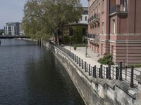 a very long waterway in front of an office building with a boat docked in it