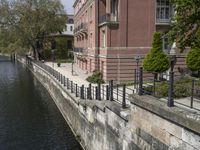 a very long waterway in front of an office building with a boat docked in it